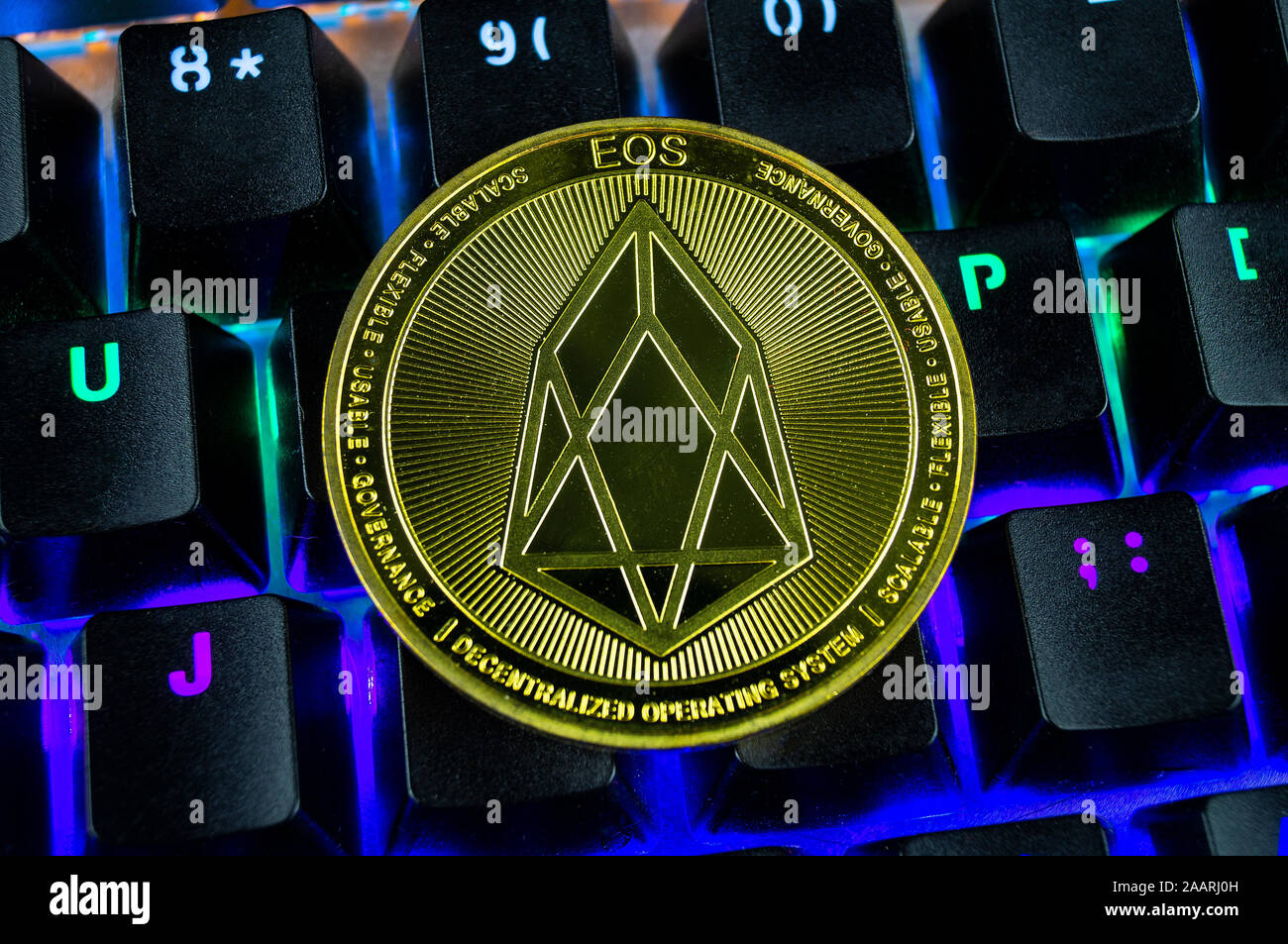Coin cryptocurrency eos close-up of the colour-coded keyboard background Stock Photo