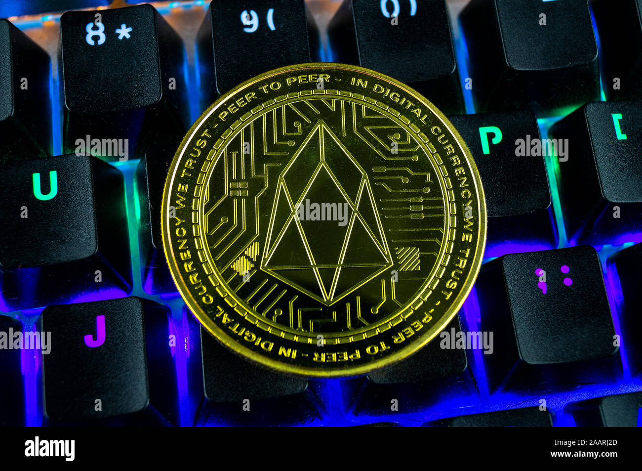 Coin cryptocurrency eos close-up of the colour-coded keyboard background Stock Photo