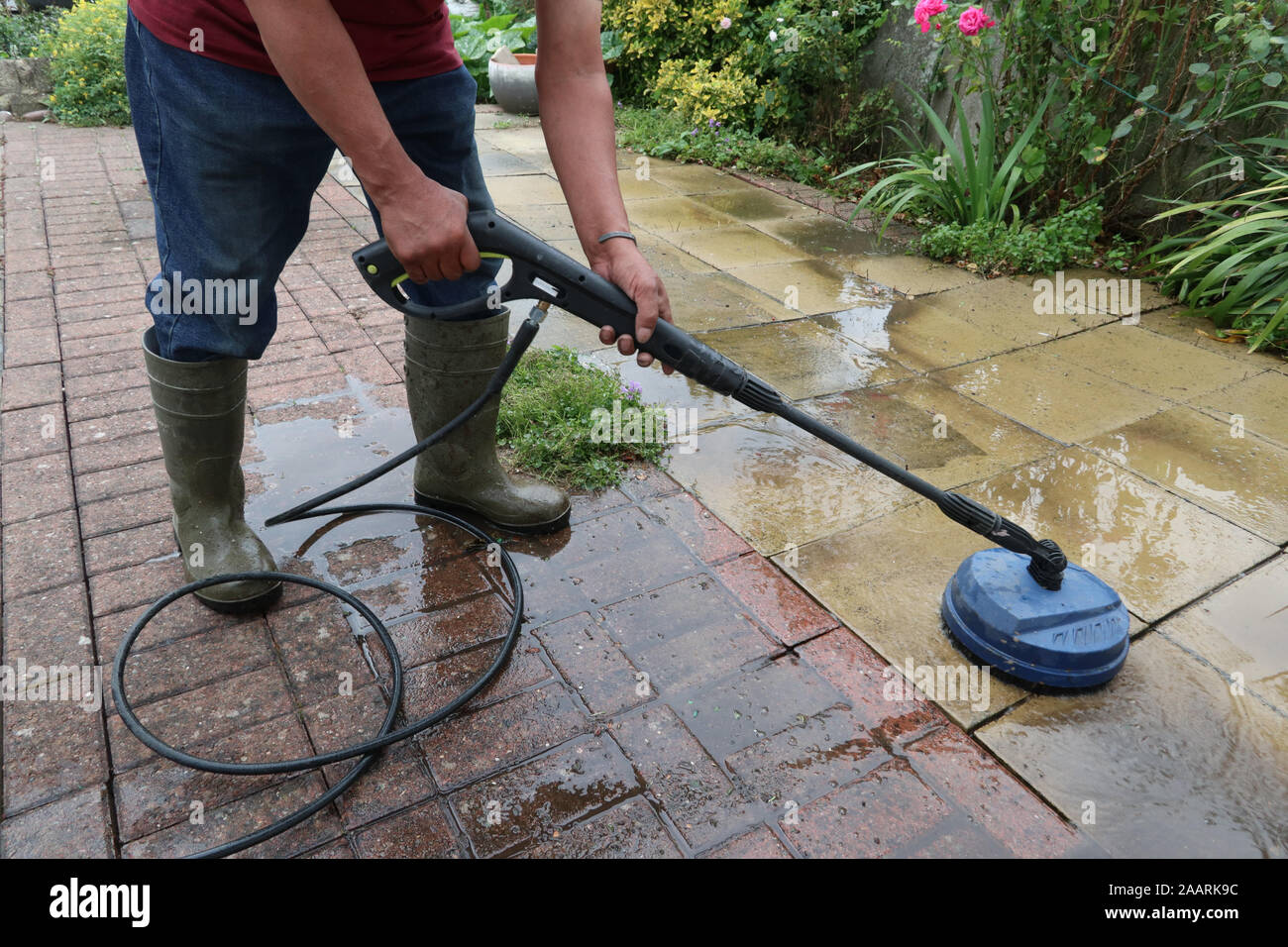 Cleaning patio paving slabs with pressure washer Stock Photo Alamy