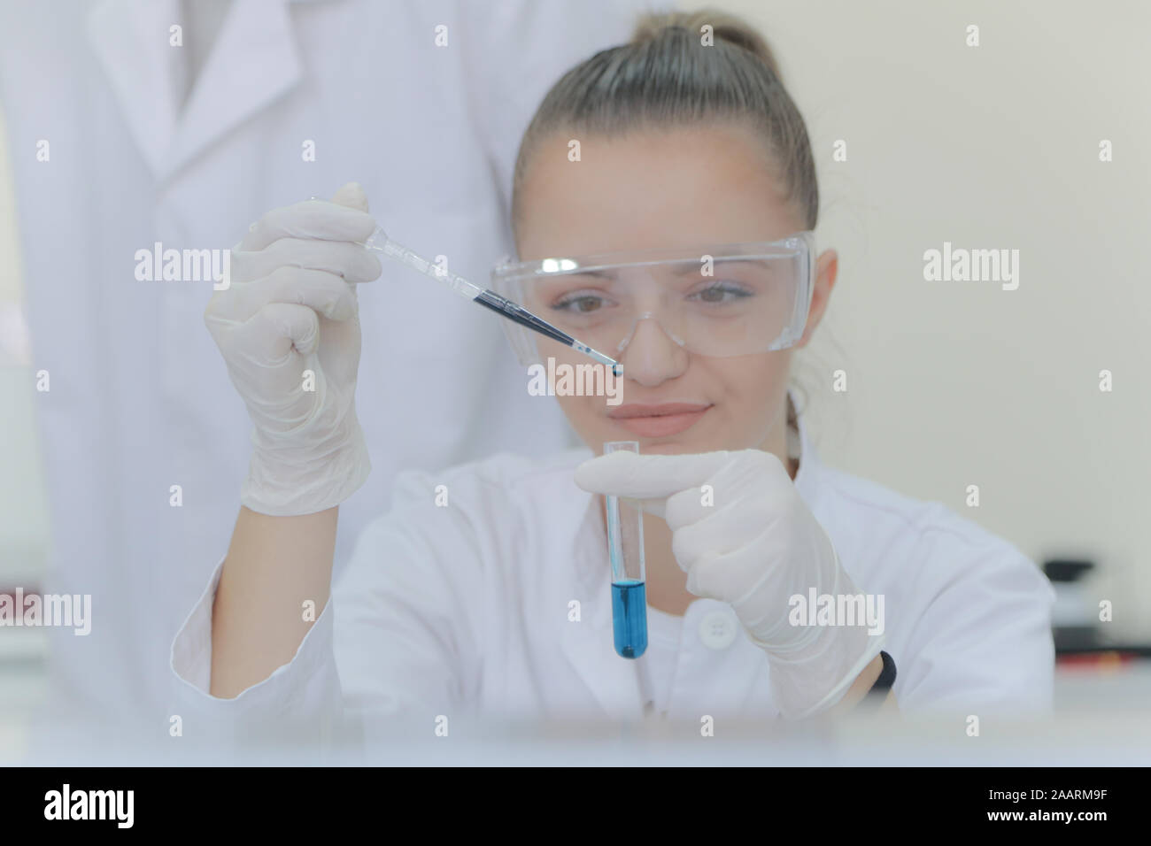Young female scientist doing experiments in laboratory Stock Photo
