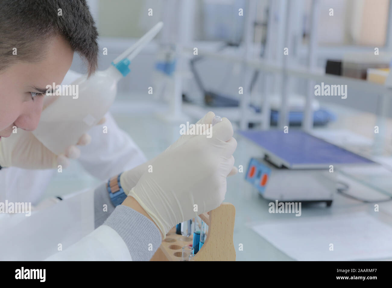 Young male scientist doing experiments in laboratory Stock Photo