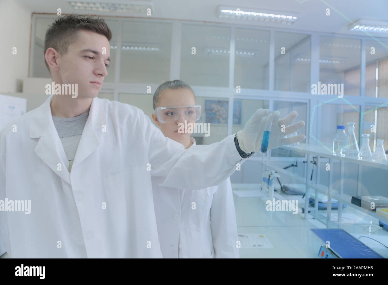 Two young students scientists doing experiments in laboratory Stock Photo