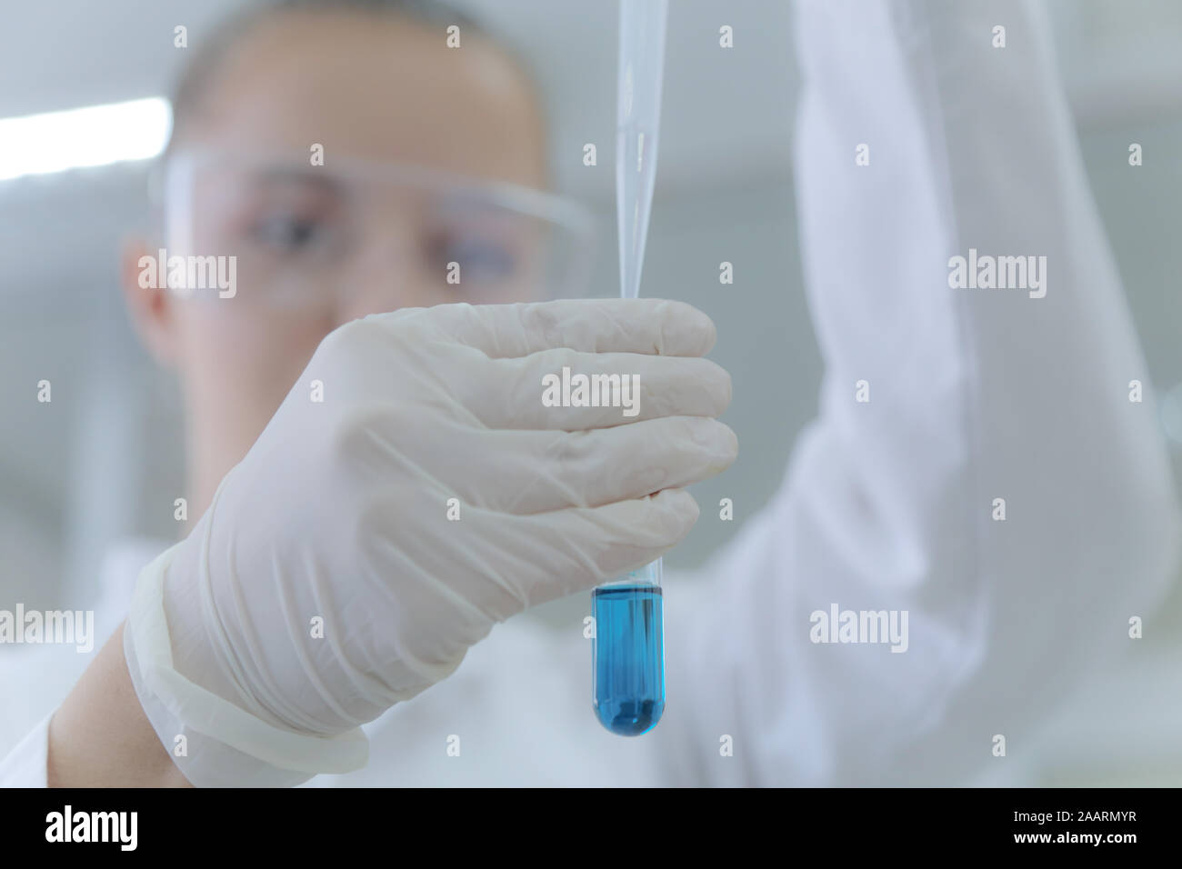 Young female scientist doing experiments in laboratory Stock Photo