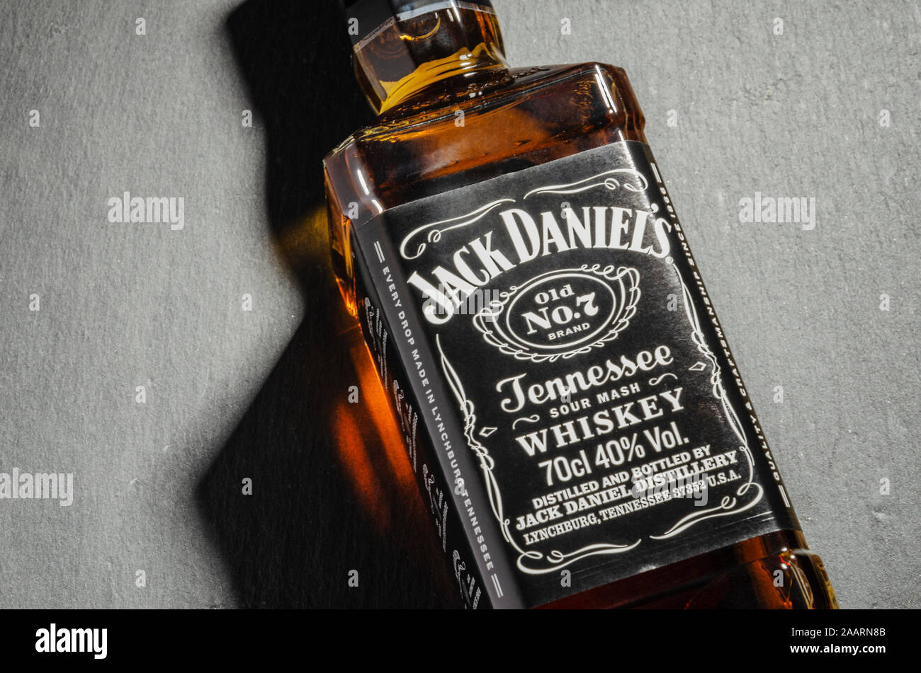 Bottle of Jack Daniels whiskey isolated on stone slate background. Jack