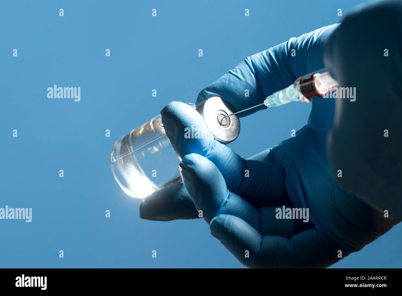 Nurse prepares to draw liquid into syringe from vial Stock Photo Alamy