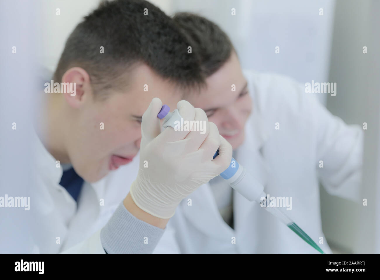 Two young male scientists doing experiments in laboratory Stock Photo