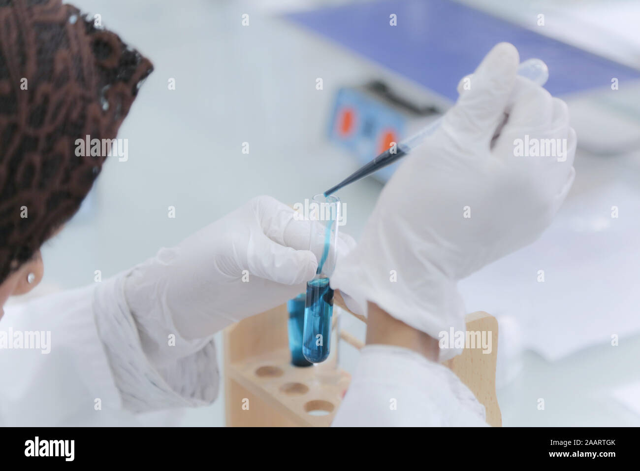 Young afro female scientist doing experiments in laboratory Stock Photo ...