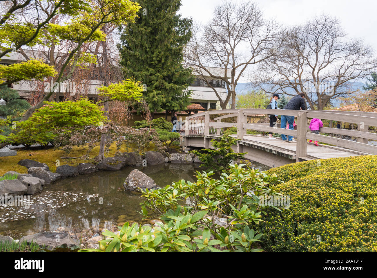 Kelowna, British Columbia/Canada - family stands on bridge at Kasugai Japanese Gardens, a popular public garden in the downtown area Stock Photo