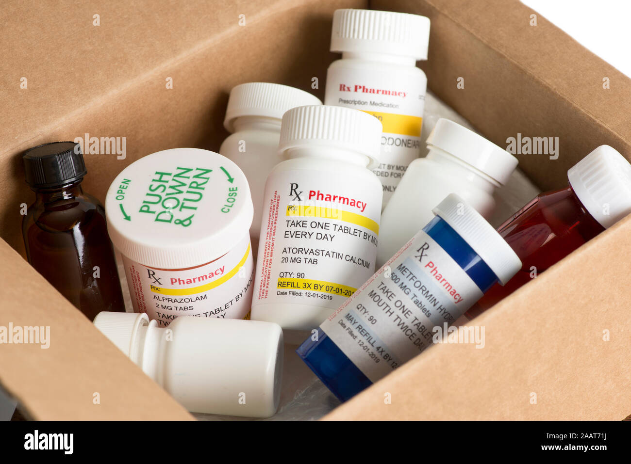 Assorted mail order prescription medications in postal shipping box. Stock Photo