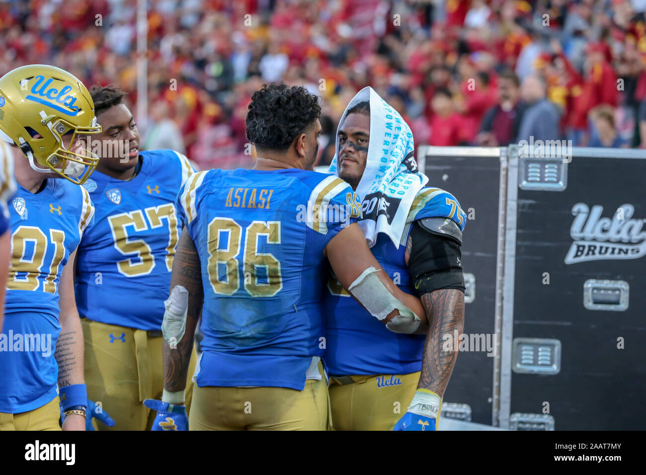 UCLA Bruins tight end Devin Asiasi (86) embracing UCLA Bruins offensive lineman Boss Tagaloa (75) during the UCLA Bruins vs USC Trojans football game at United Airlines Field at the Los Angeles Memorial Coliseum on Saturday November 23, 2019 (Photo by Jevone Moore) Stock Photo