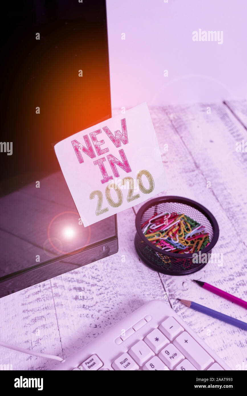 Writing note showing New In 2020. Business concept for list of fresh ...
