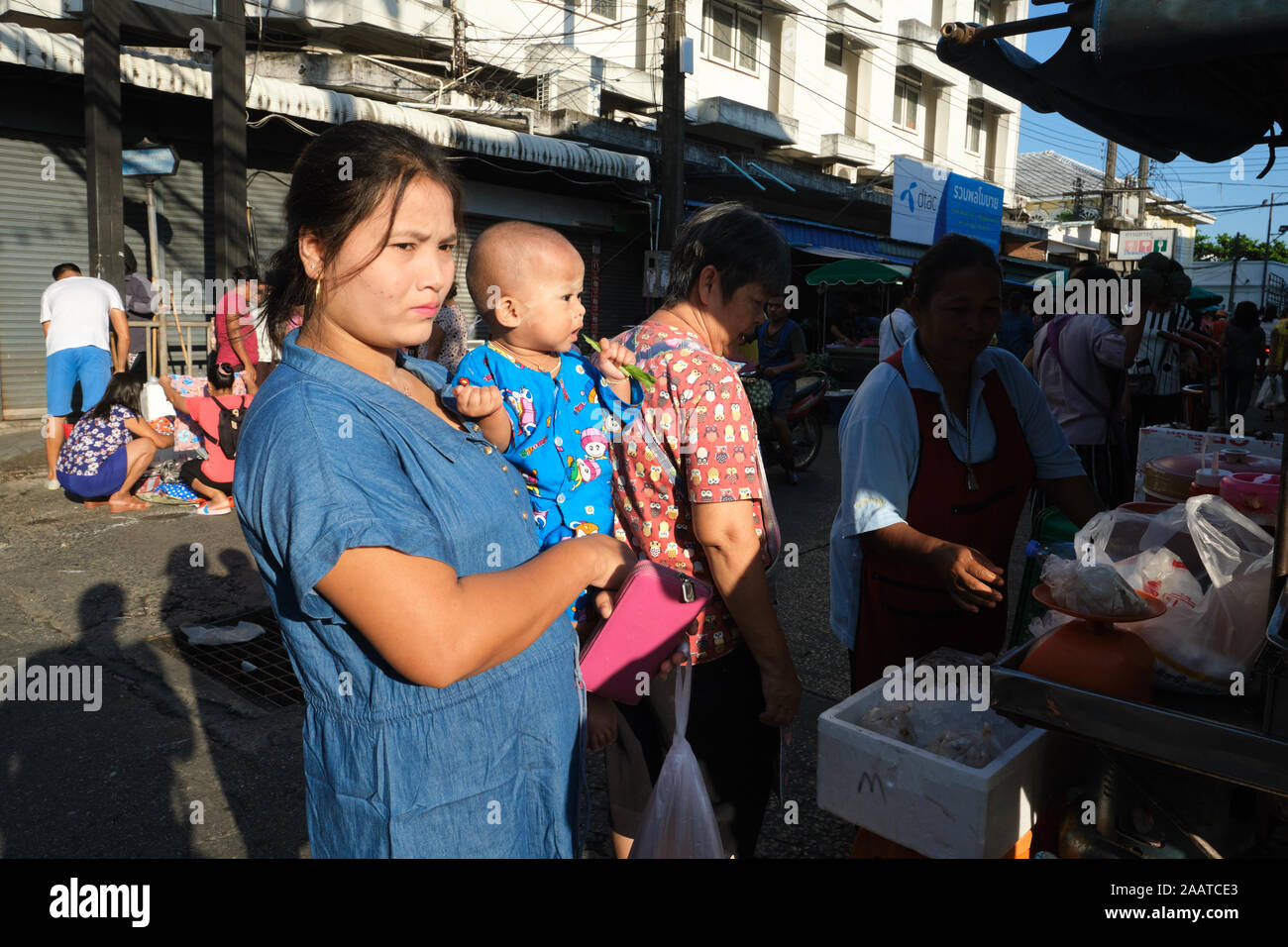 A Myanmarese (Burmese) female migrant worker and her child out for Sunday shopping in the main market in Phuket Town, Phuket, Thailand Stock Photo