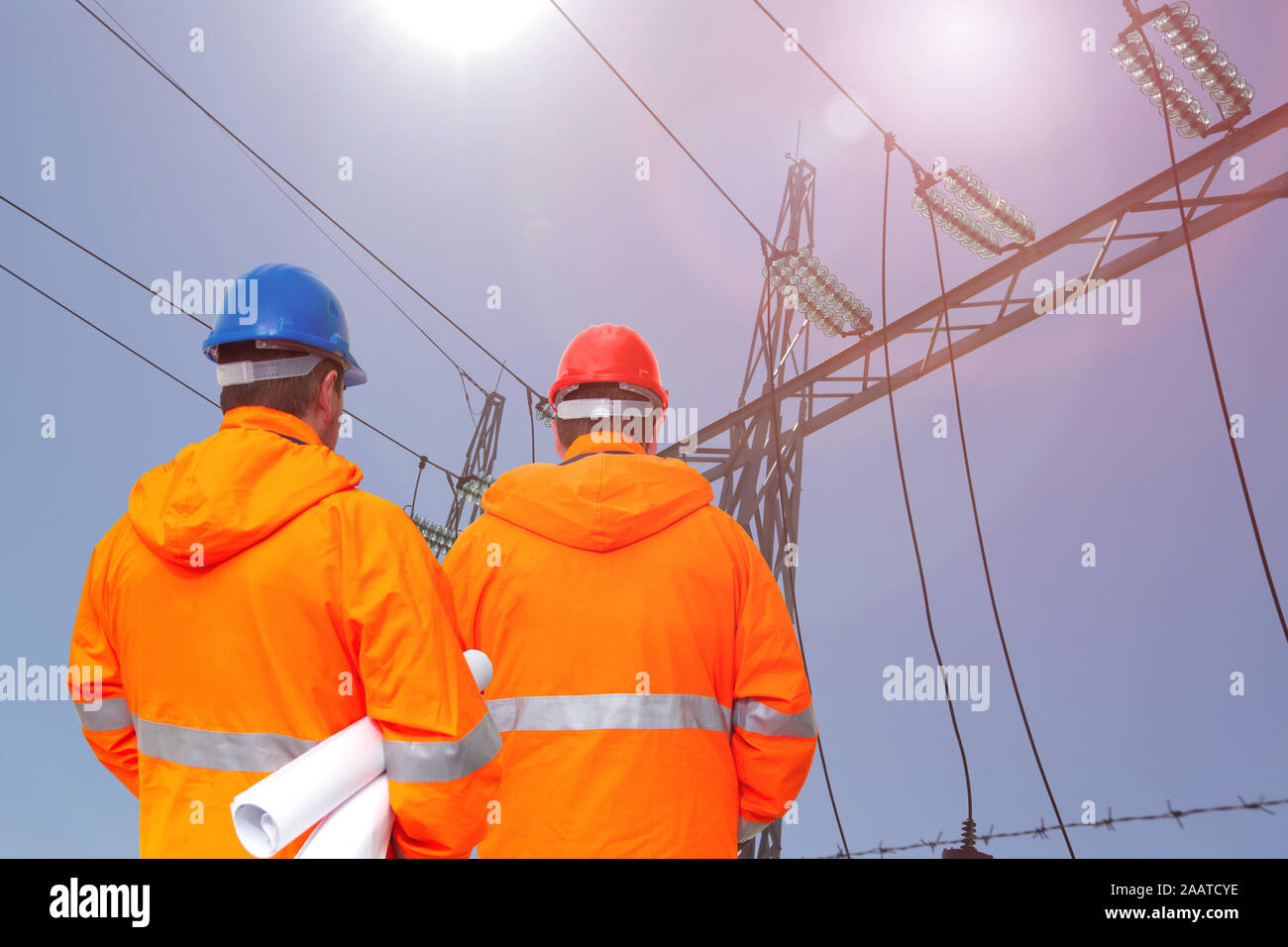 Two electrical engineers in substation, back view Stock Photo