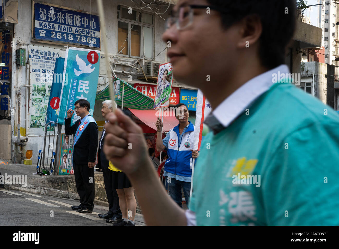Candidates campaign for final support from voters outside a polling station.Hong Kong voters queue up by the hundreds at local polling stations for district council elections, citing concerns from both pro-democracy and pro-establishment camps that voting could be halted later in the day. Against the backdrop of continuing social unrest that has paralyzed the city since June, Hong Kong is expecting one of the largest turn out of voters since the establishment of the special administrative region. Stock Photo