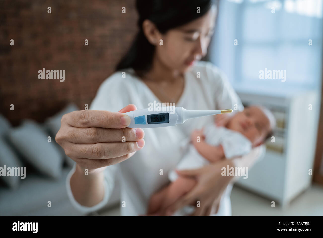 Mother with baby newborn and thermometer Stock Photo Alamy