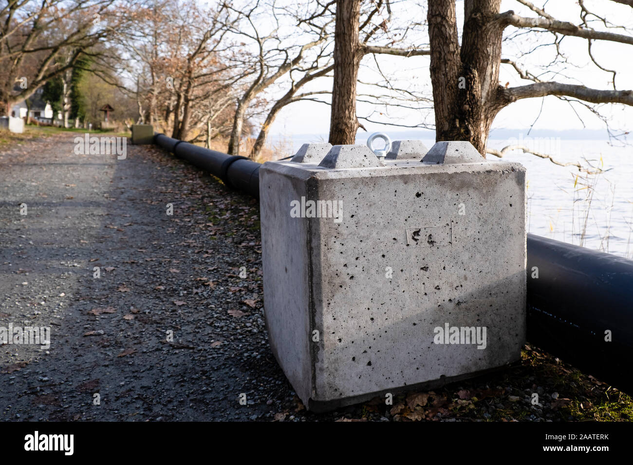 Flensburg, Germany. 22nd Nov, 2019. A concrete block lies on the bank of the Flensburg Fjord. In a few days the controversial wild boar fence at the German-Danish border should have been finished. The Danes are building the fence from the North Sea to the Baltic Sea; it is to be a 70 kilometre long and 1.50 metre high bulwark to protect domestic pig farming from African swine fever (ASP). (to dpa 'That doesn't fit me at all' - Denmark's wild boar fence almost complete) Credit: Frank Molter/dpa/Alamy Live News Stock Photo