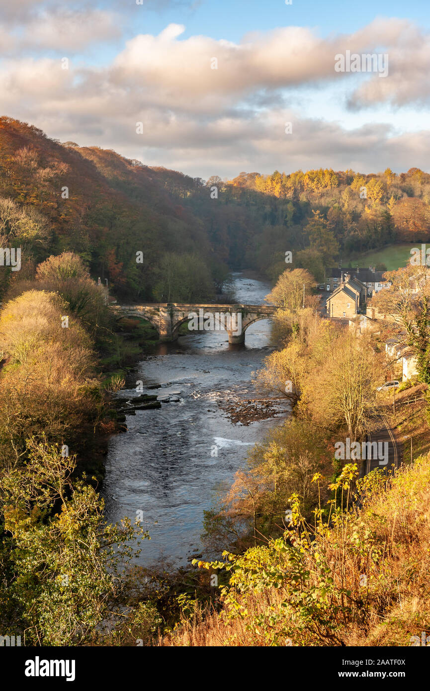 The Green Bridge over the River Swale as seen from the Castle Walk on a vibrant autumn afternoon in golden sunlight Stock Photo