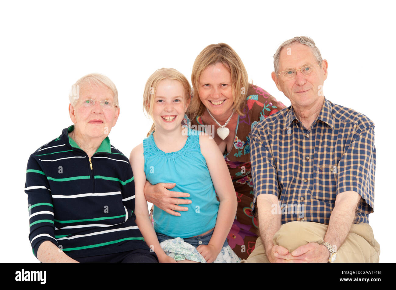Close up of grandparents, mother and daughter together on a white