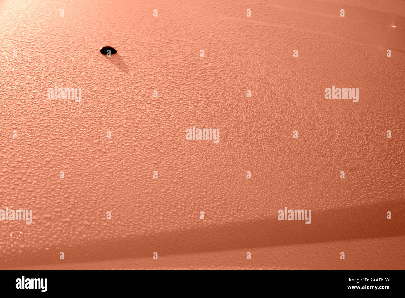 Water drops on the metal surface close up. Abstract background orange color toned Stock Photo