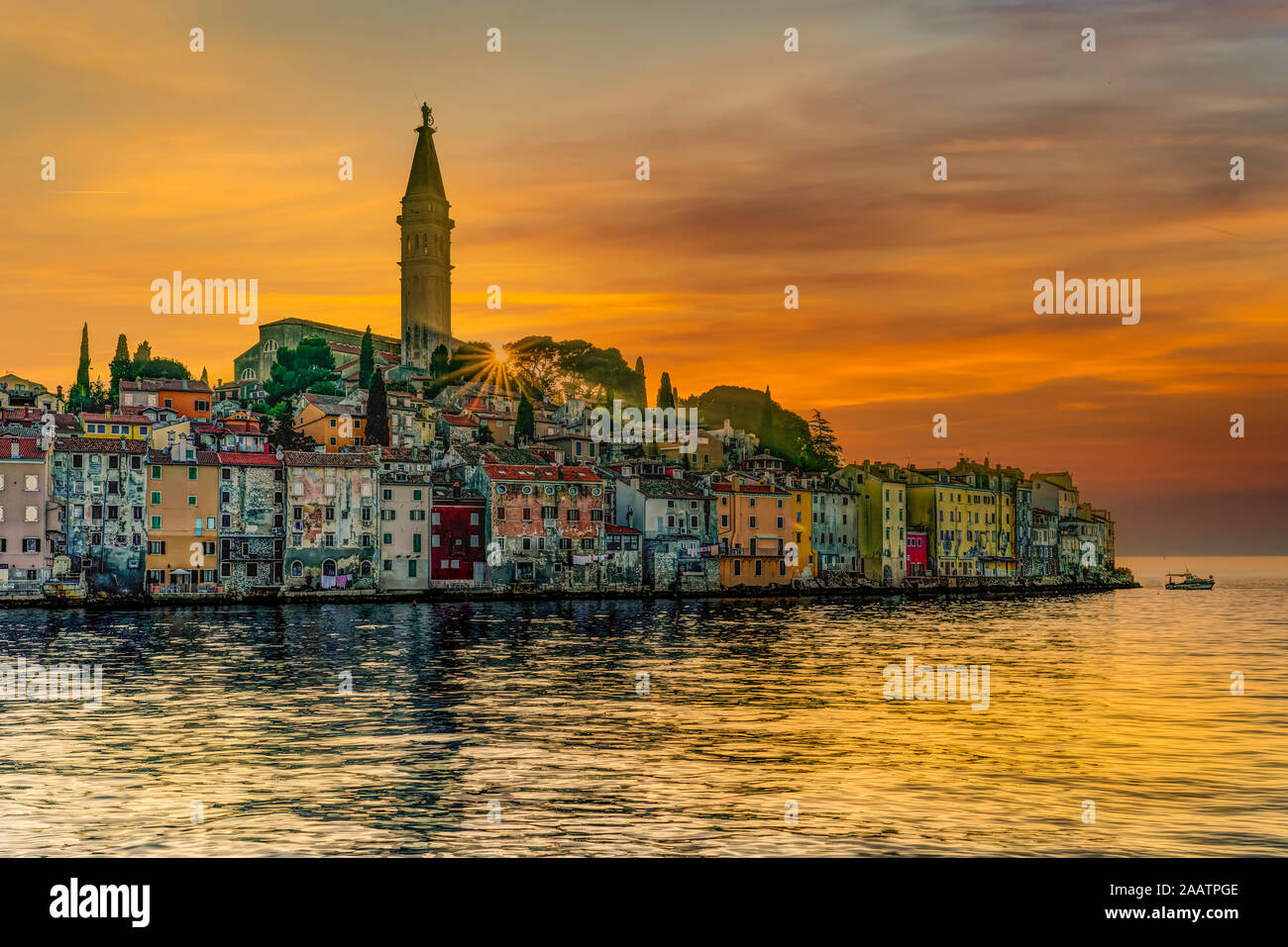 The village skyline and the Adriatic Sea at sunset at Rovinj, Croatia, Istria. Stock Photo