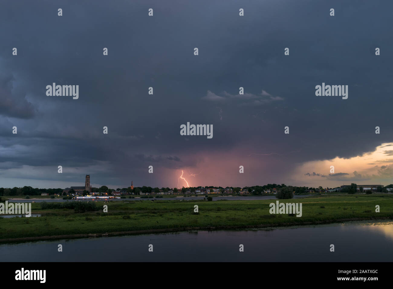 Lightning strikes down to earth from an evening thunderstorm over the