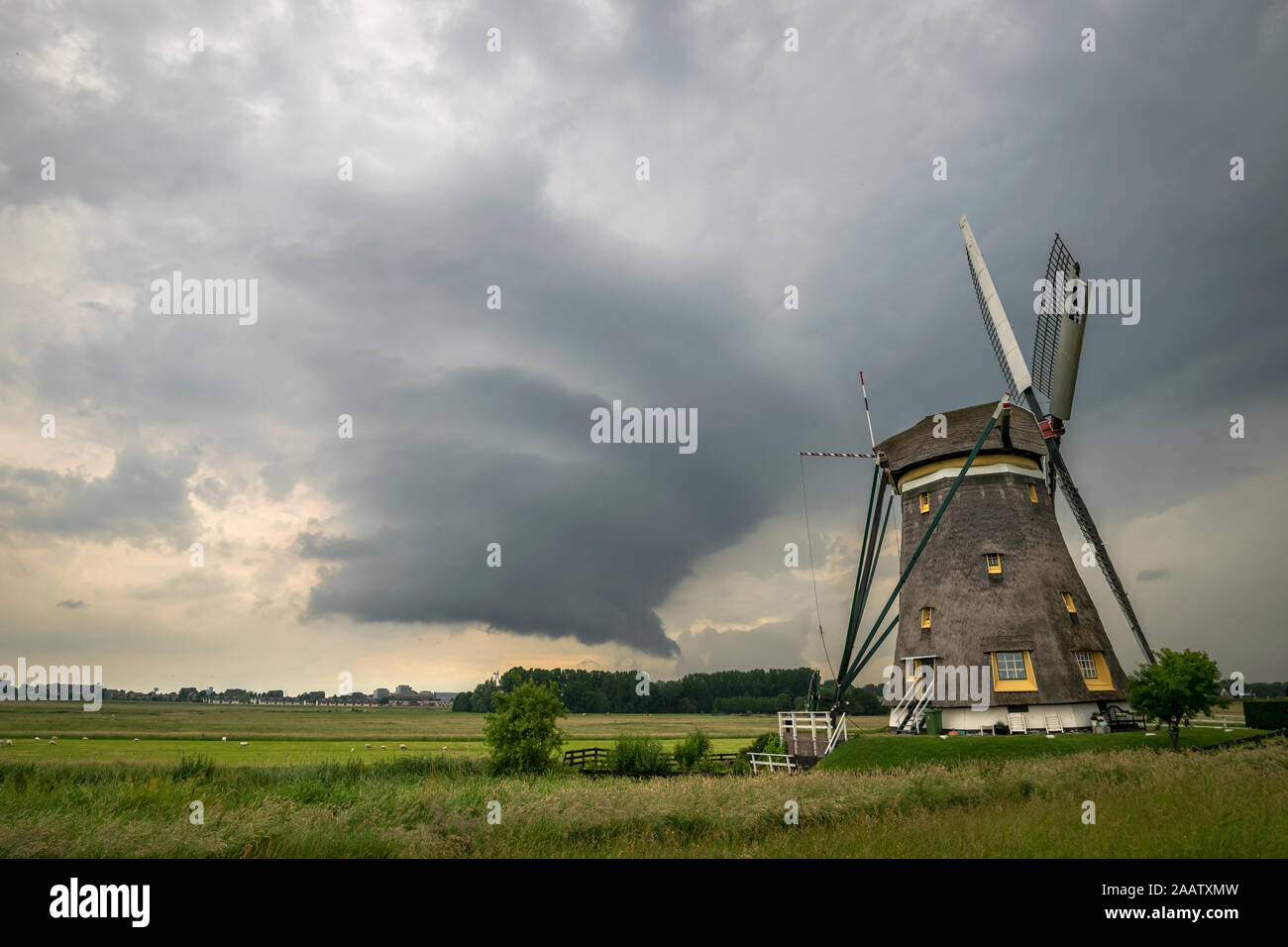 Wallcloud of a supercell thunderstorm near a windmill in The Netherlands Stock Photo