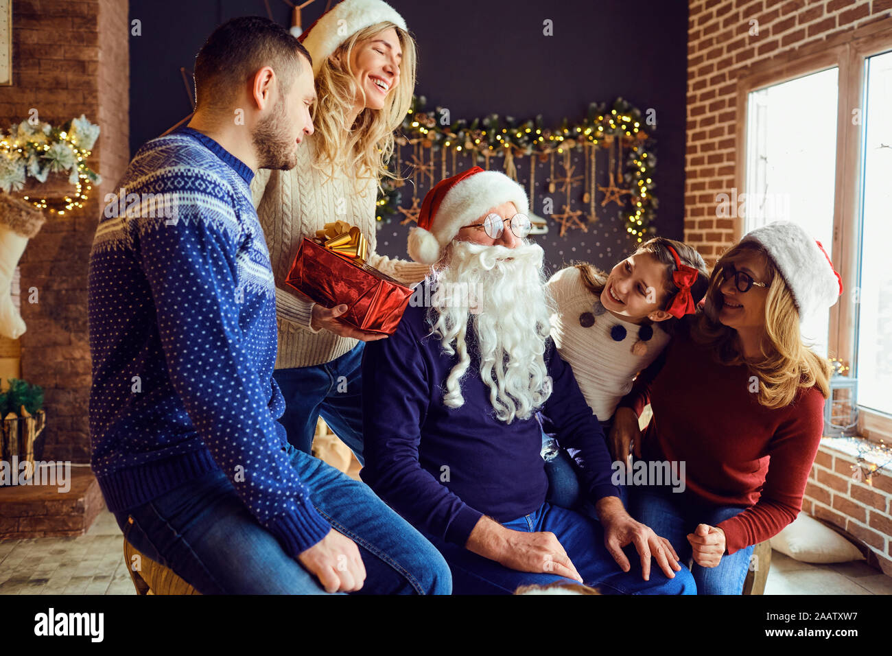 Happy family in house with christmas tree celebrates christmas. Stock Photo