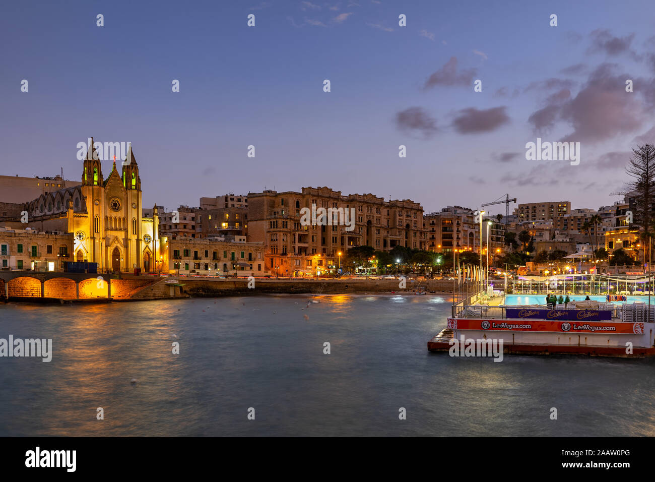 St julian town at dusk in malta illuminated carmelite church at