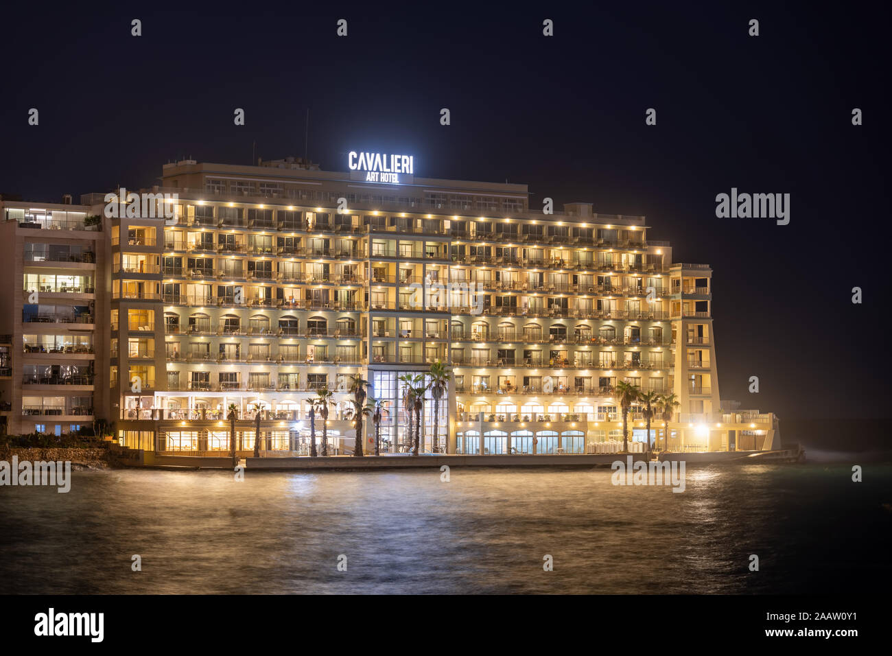 The Cavalieri Art Hotel at night in St. Julian town, Malta, four star accommodation with view to Balluta Bay Stock Photo