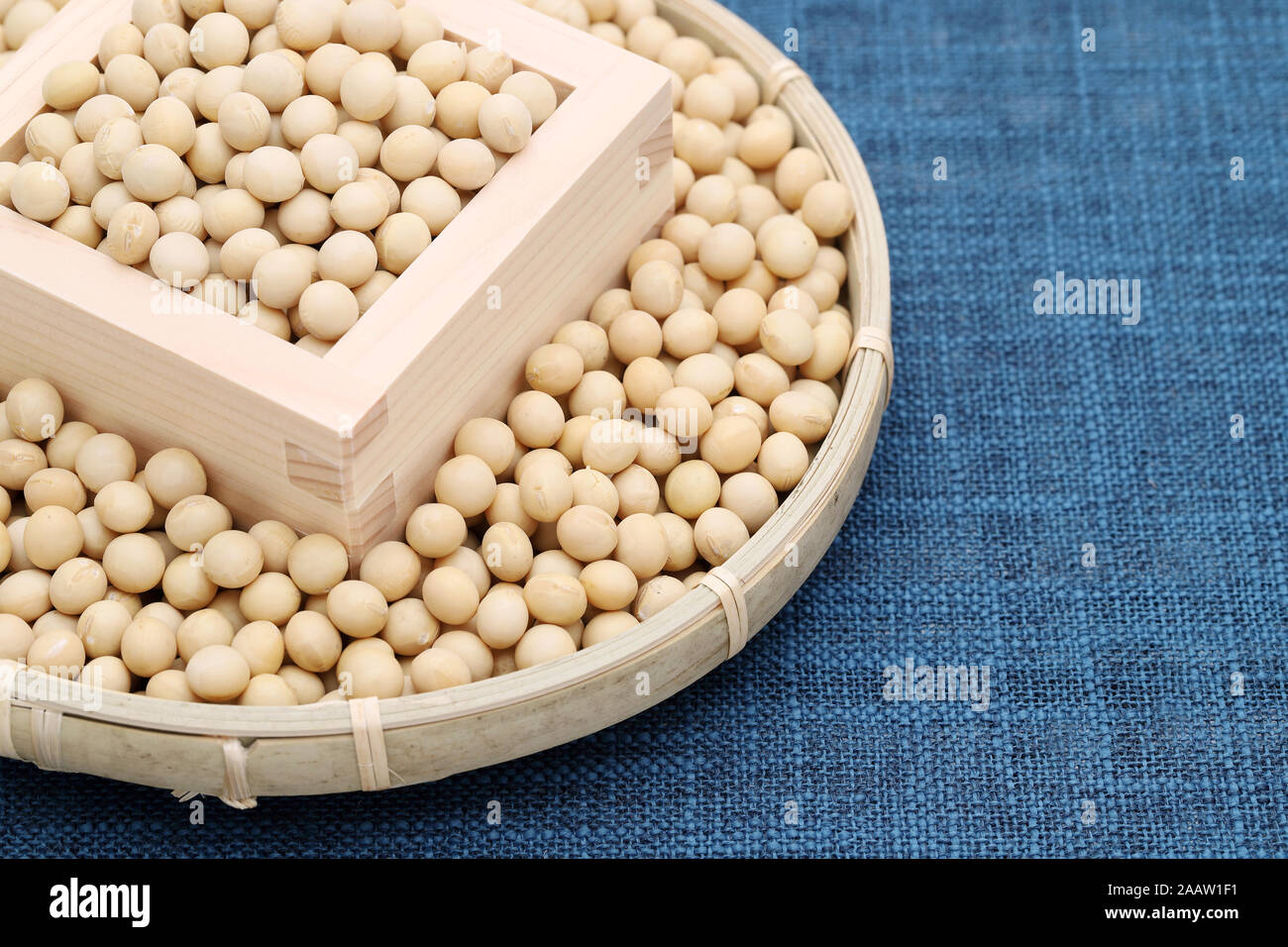 Japanese soybeans daizu in a wooden masu and bamboo basket Stock Photo
