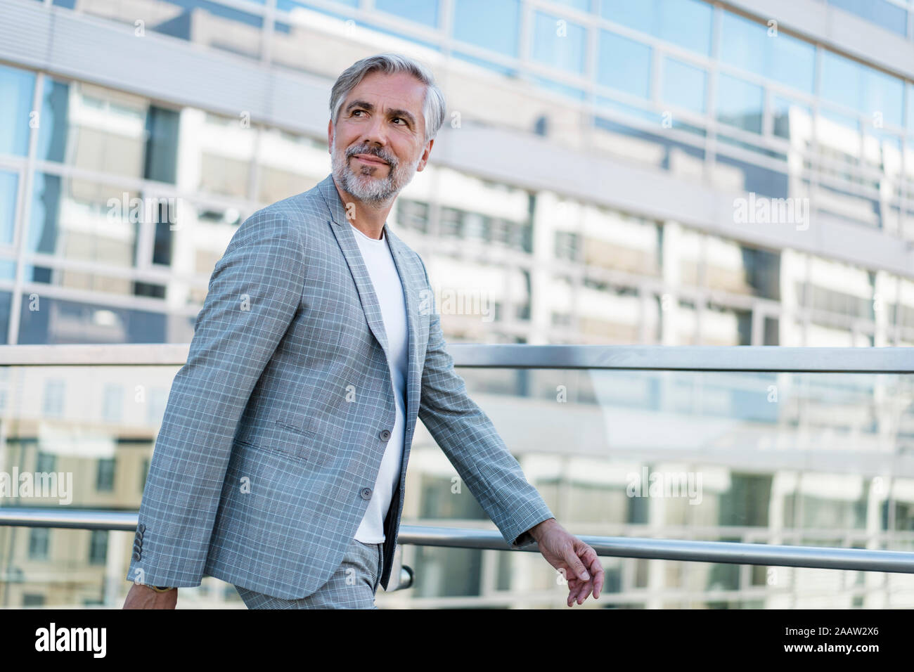 Confident mature businessman on the go looking around Stock Photo - Alamy