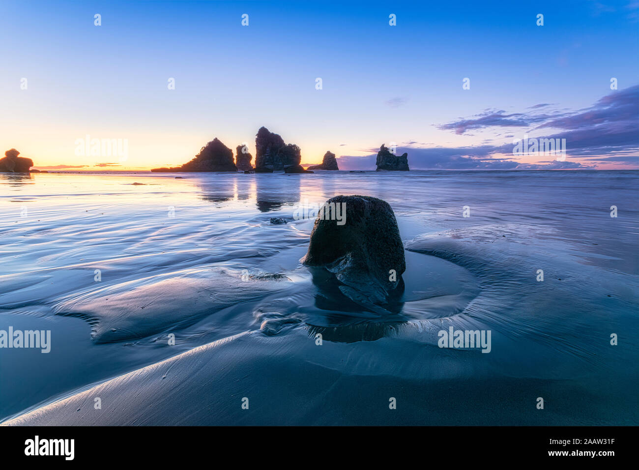 New Zealand, South Island, Silhouettes of Motukiekie Beach sea stacks at sunset Stock Photo