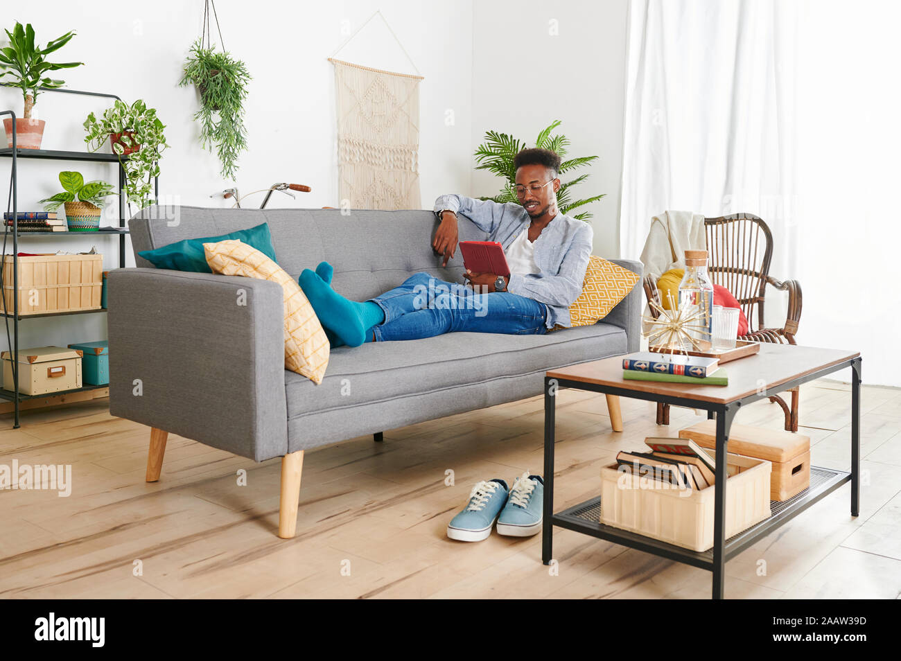 Young man using tablet at living room Stock Photo