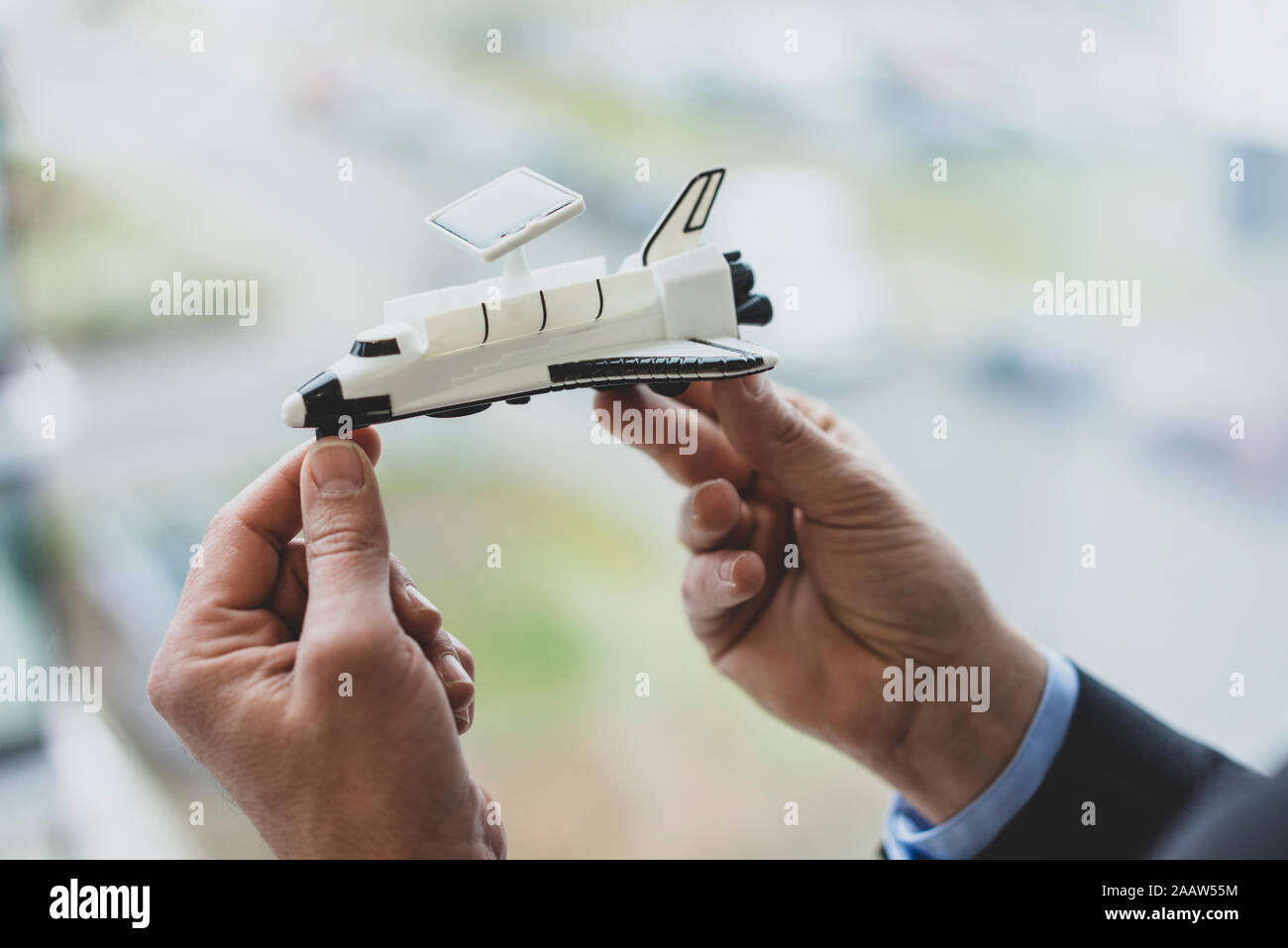 Close-up of bussinessman holding space shuttle model Stock Photo