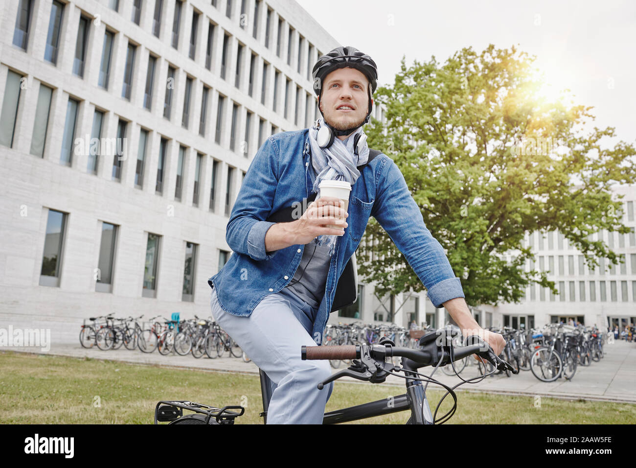 Student with coffee to go and e-bike Stock Photo
