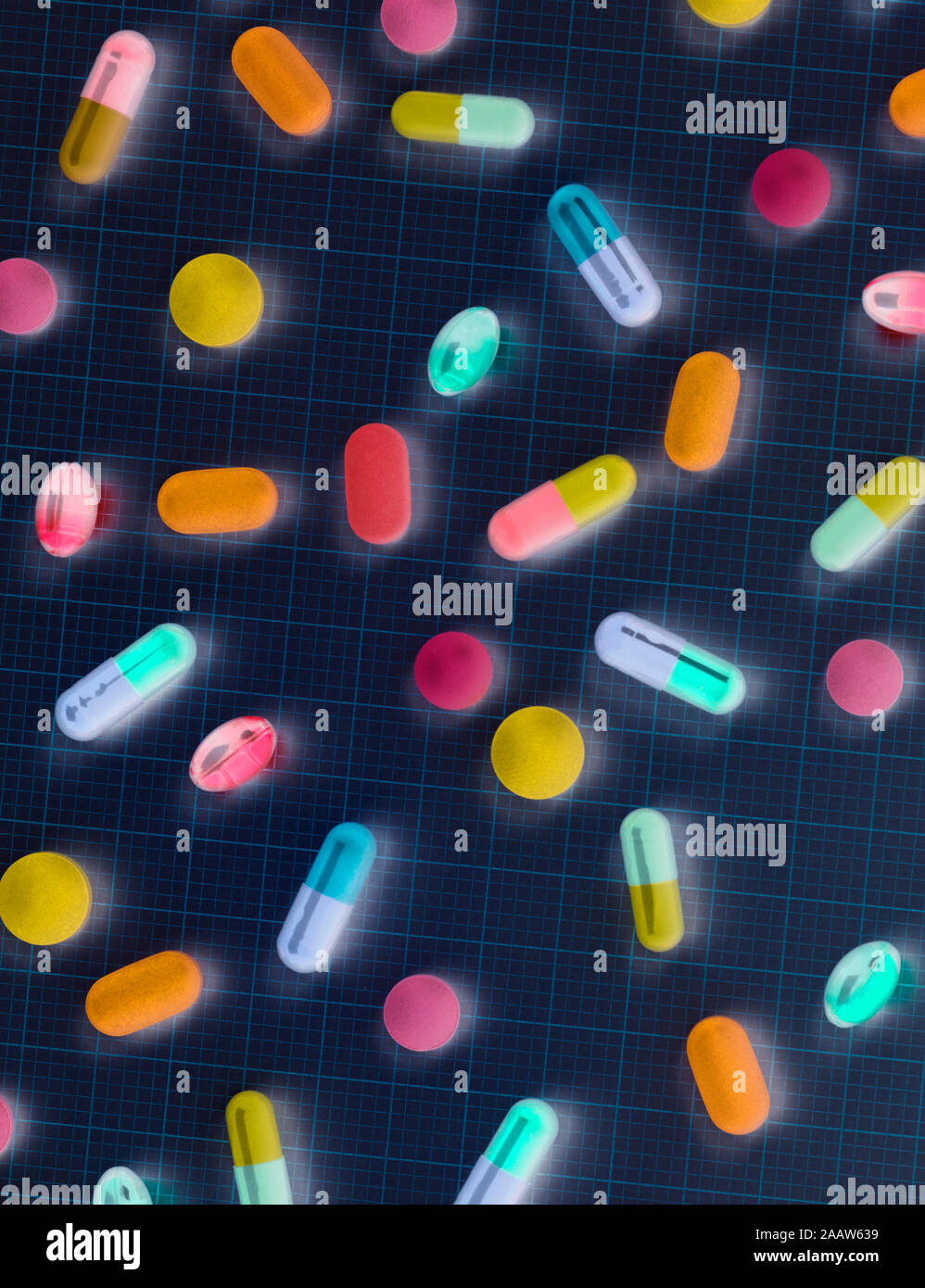 Directly above shot of colorful medicines on graph paper Stock Photo
