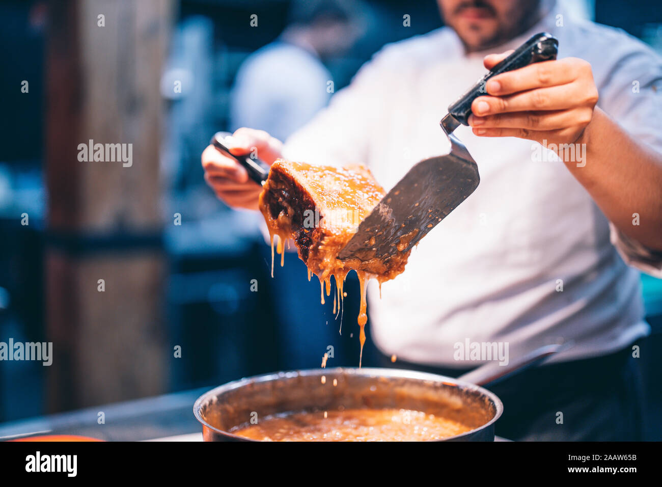 Cook at work in a restaurant kitchen Stock Photo