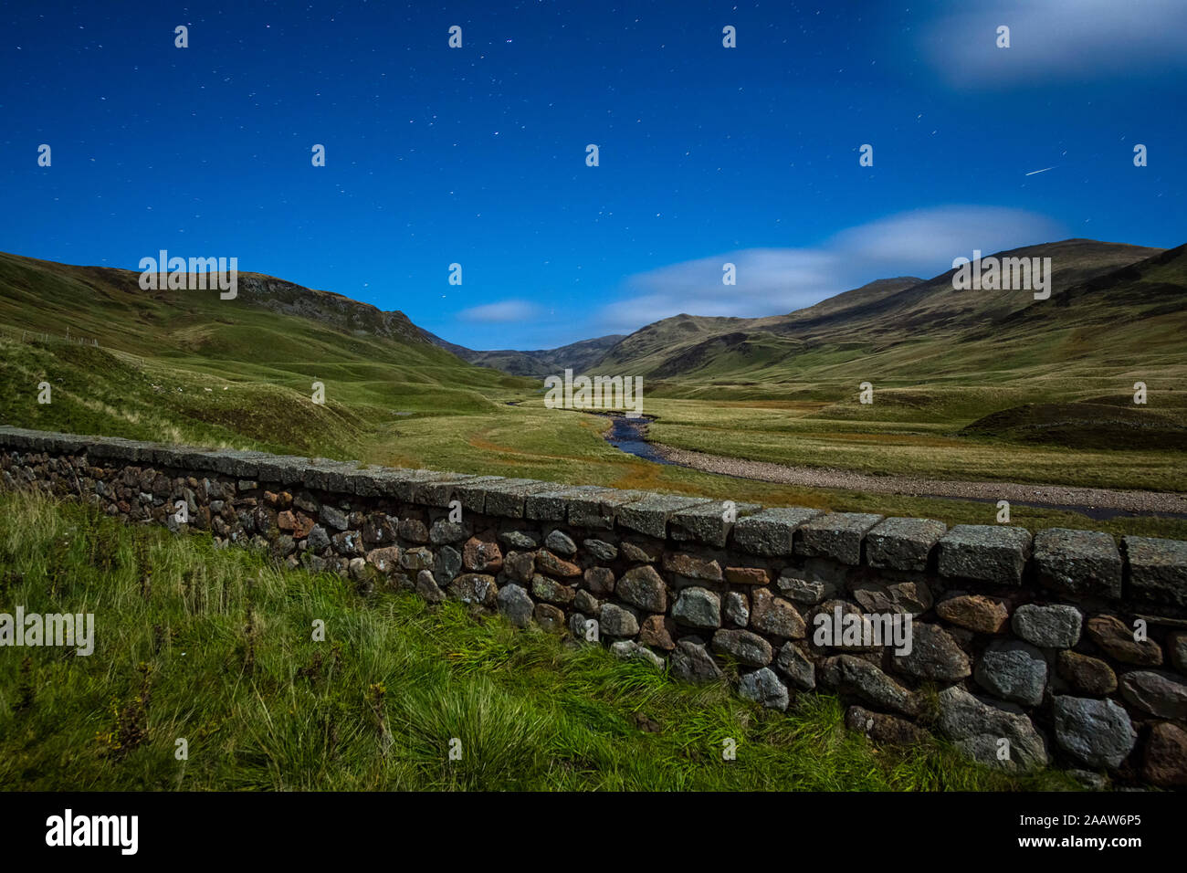 UK, Scotland, Glenshee, landscape with stone wall under starry sky Stock Photo