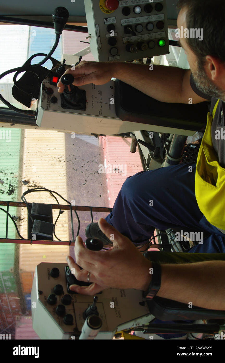 Gantry crane operator moving a sea container in the Port Stock Photo ...