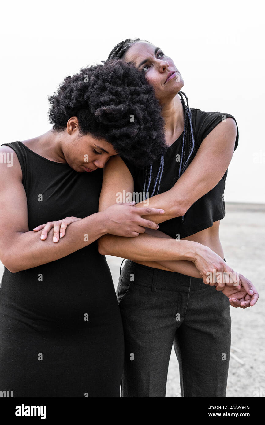 Two women holding each other Stock Photo - Alamy