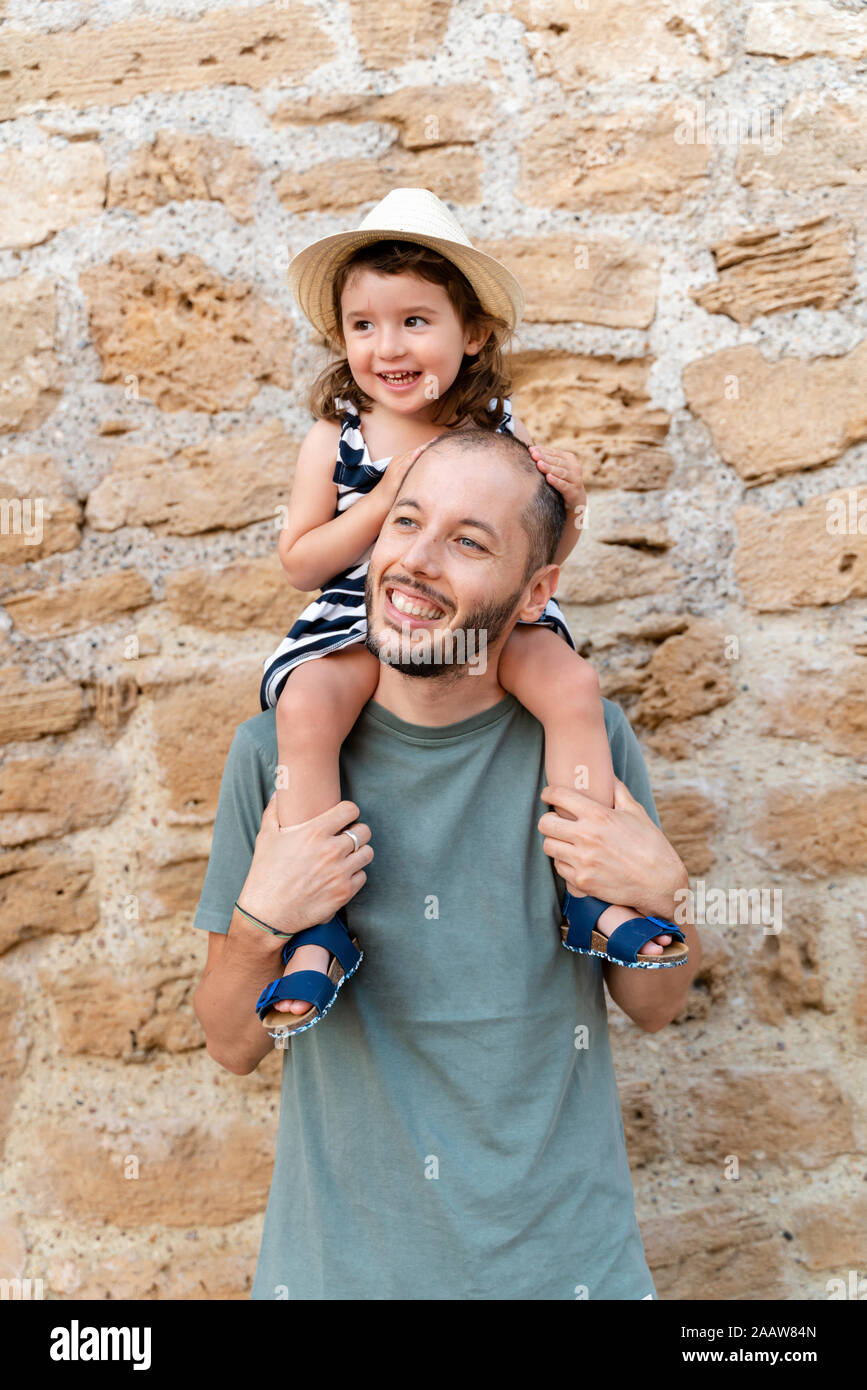 Portrait of happy little girl on her father's shoulders Stock Photo