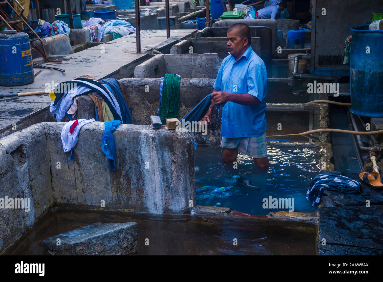 MUMBAI , INDIA - AUG 26 : Indian man work at Dhobi Ghat in Mumbai India on August 26 2019 Dhobi Ghat is an open air laundry in Mumbai over 7,000 peopl Stock Photo