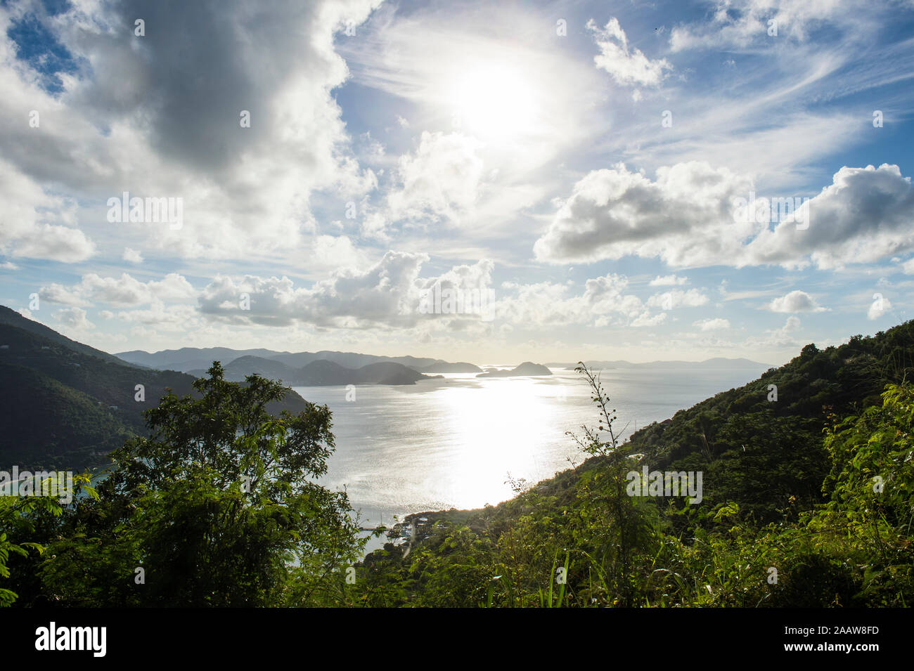Scenic view of British Virgin Islands against cloudy sky during sunny day Stock Photo