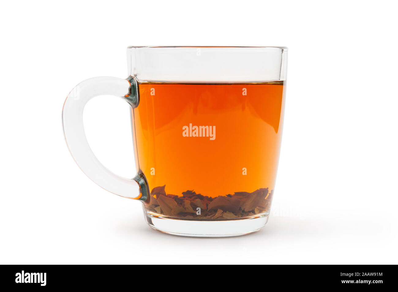 Tea with tea leaves in glass cup isolated on white background Stock