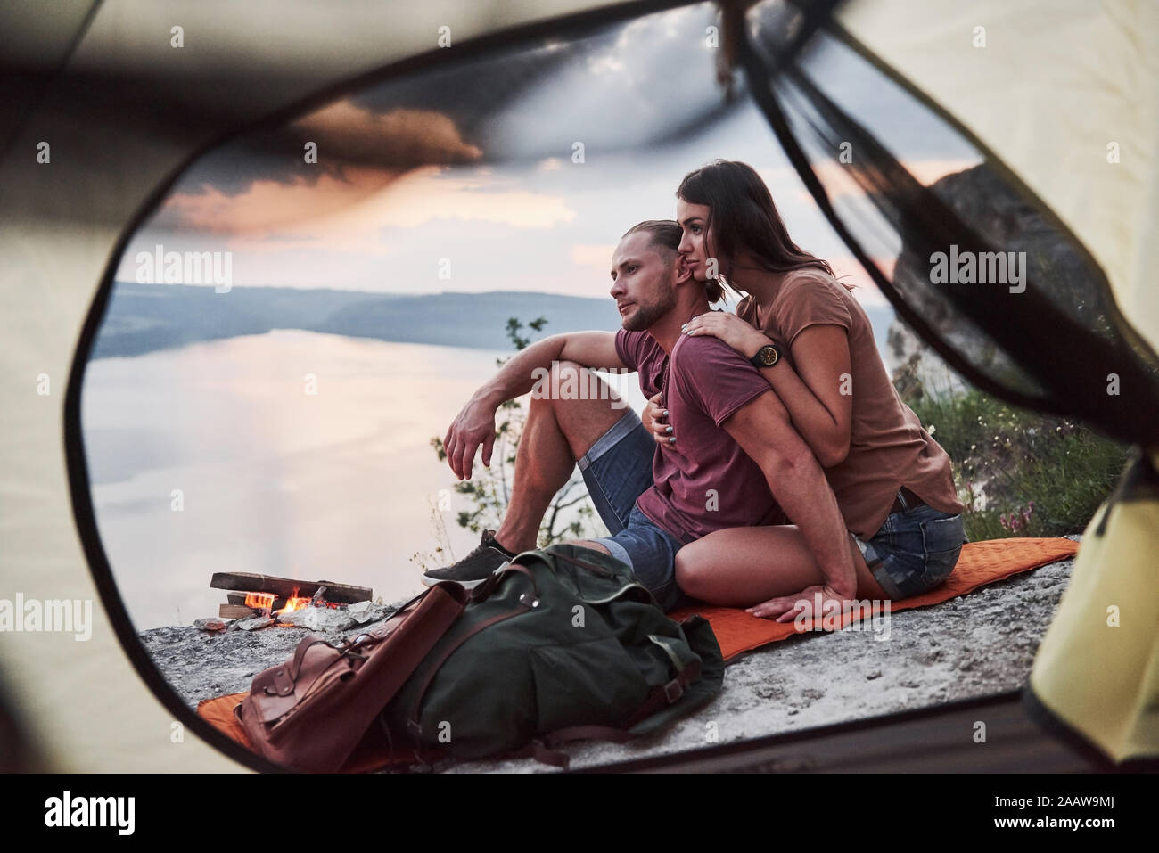 View from tent of couple lying a view of lake during hiking trip. avel Lifestyle concept adventure vacations outdoor Stock Photo