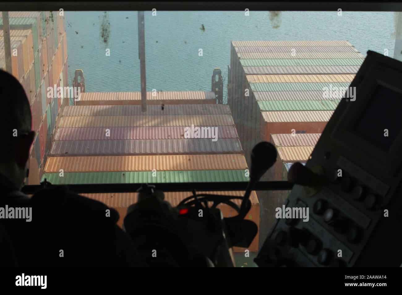 Gantry crane operator moving a sea container in the Port Stock Photo ...