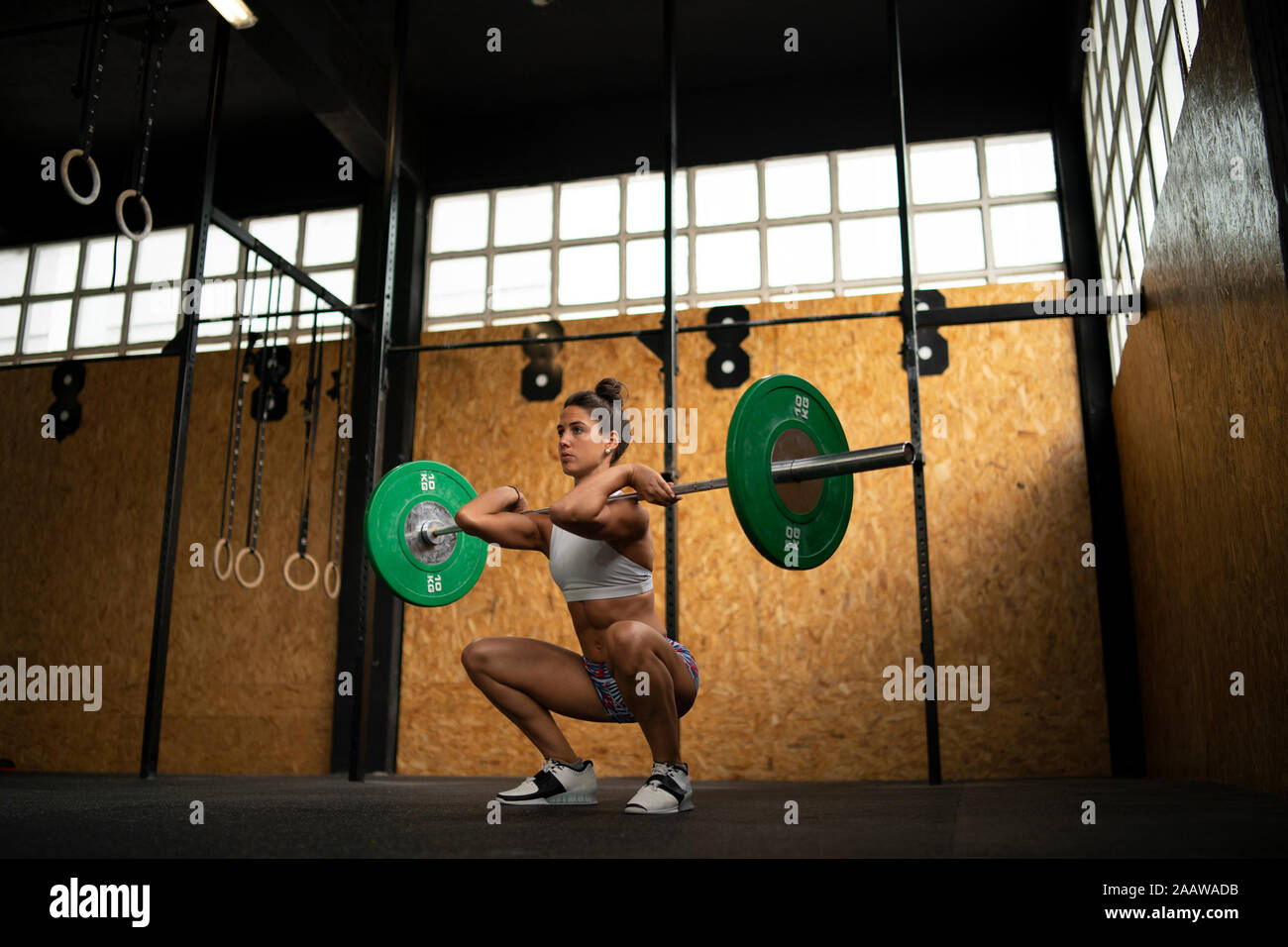 Young woman doing overhead squat exercise at gym Stock Photo Alamy