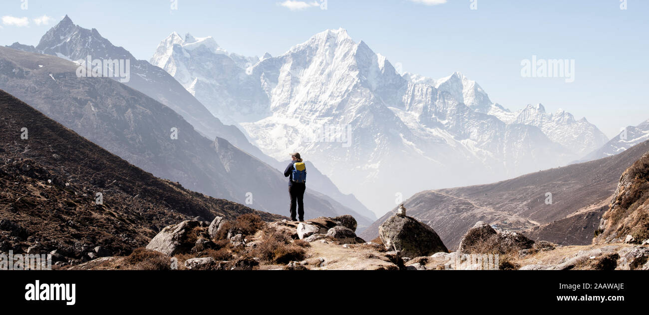 Woman trekking in the Himalayas, Nepal Stock Photo