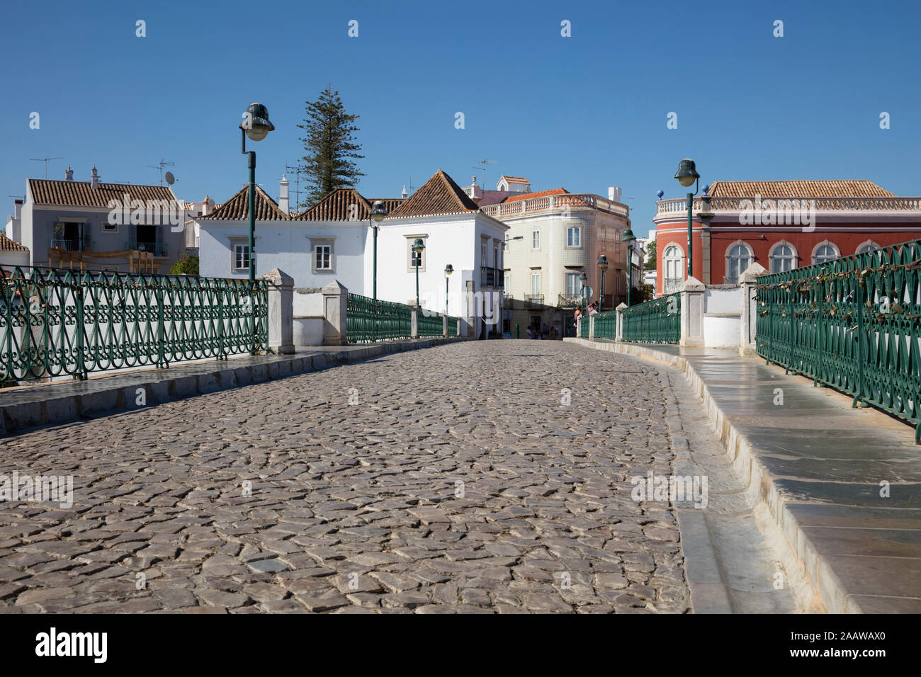 Empty old bridge against buildings in Tavira, Portugal Stock Photo