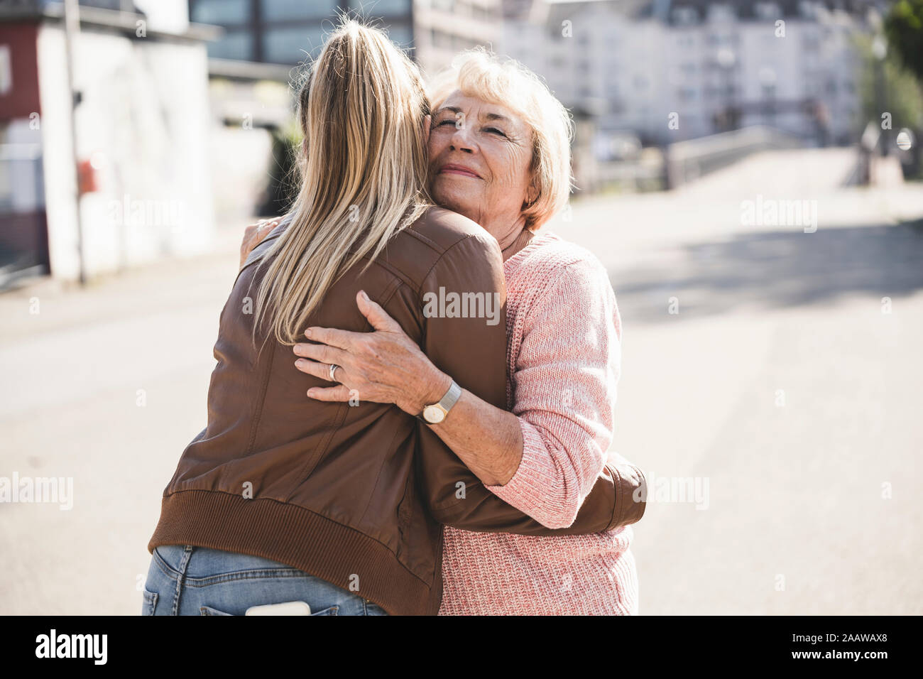 Granddaughter embracing her grandmother Stock Photo